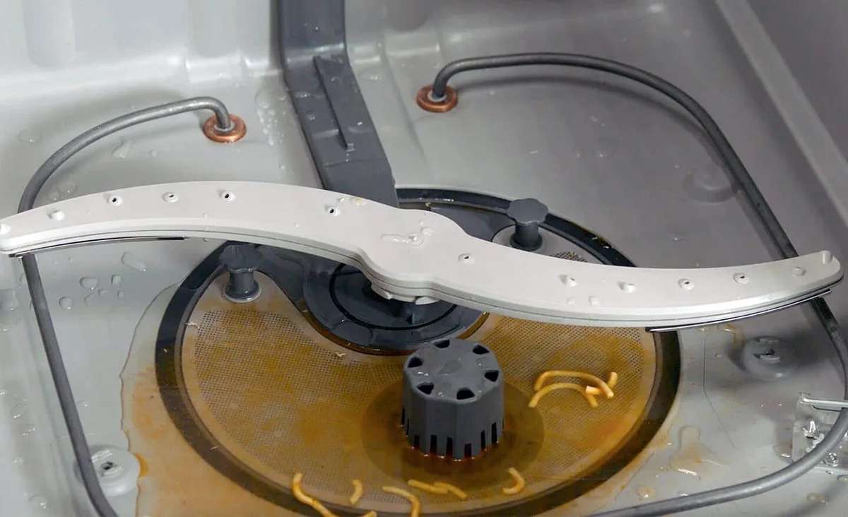 clogged wash arm jet close-up