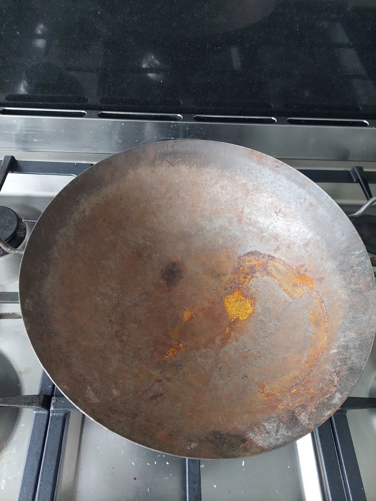 how to remove rust from cast iron wok